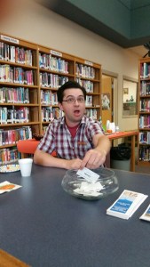 Jacob choosing the lucky winner for conference registration at the ACLA quarterly meeting at Ashley.
